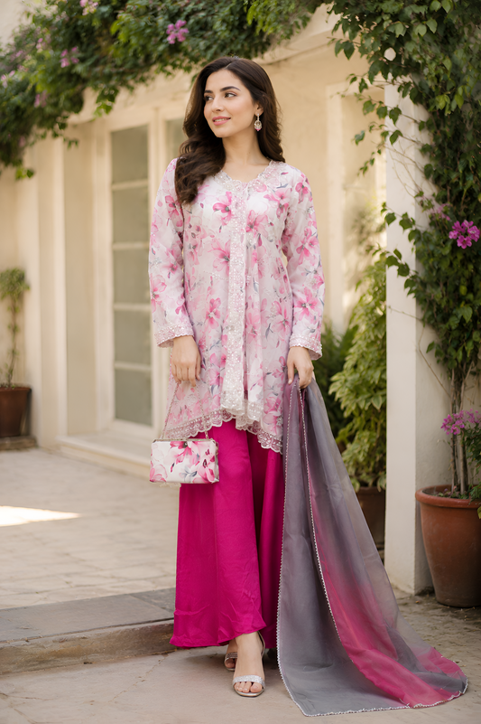 Shehr-e-Naaz digital printed crepe short frock with net embroidered lace neckline, silk charmeuse palazzo, digital printed silk dupatta, and handmade potli.