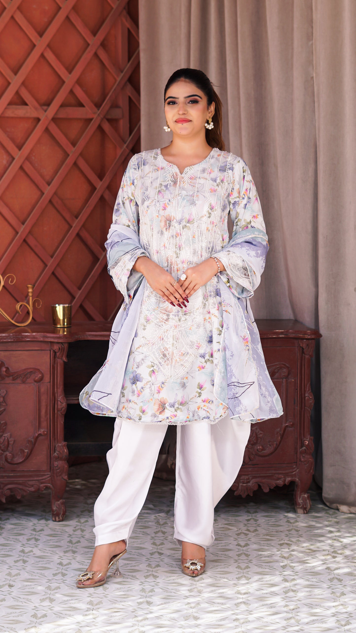 Mahroze Kurta Set featuring a light blue and white floral printed kurta with wide sleeves, white trousers, and beige heels.